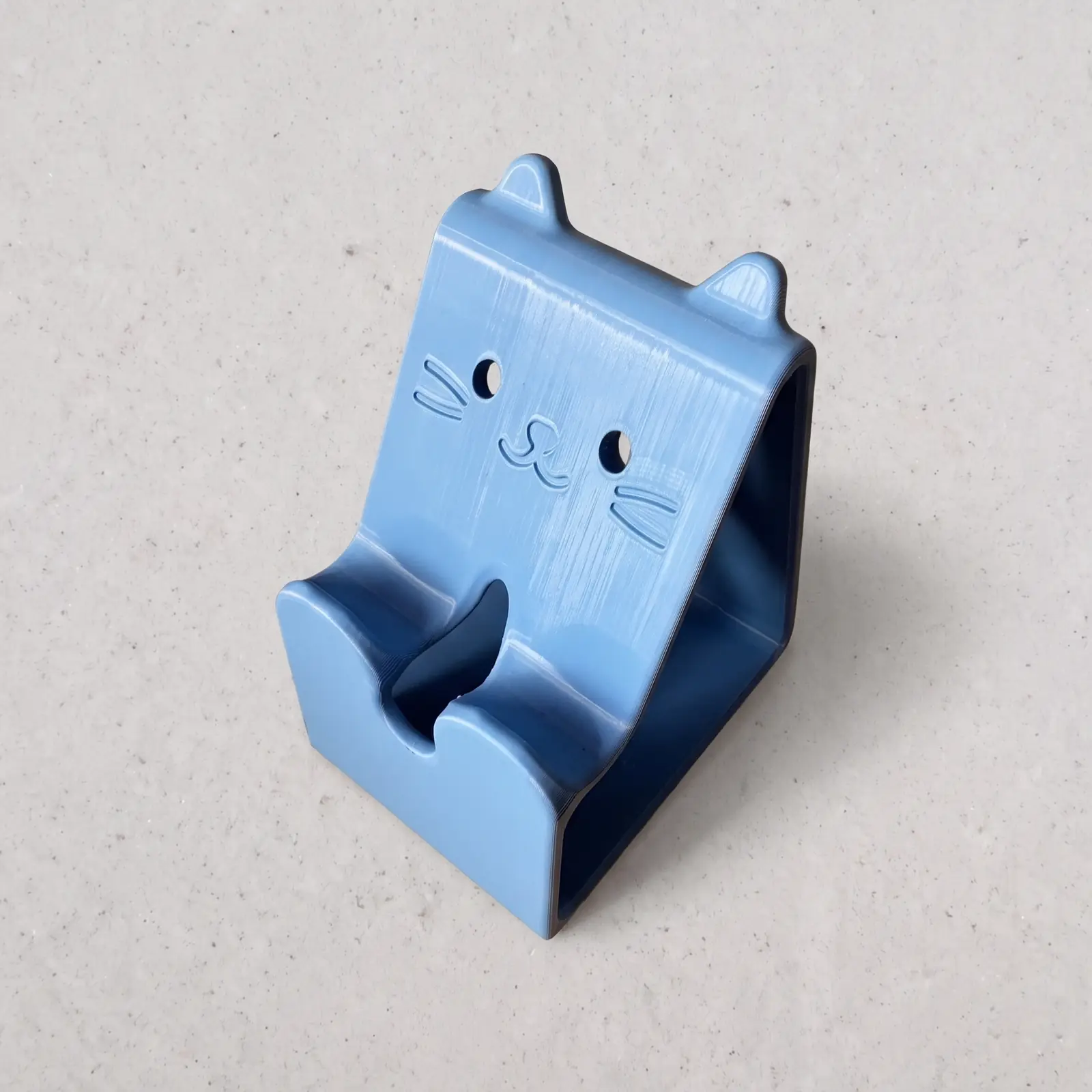 Soporte para celular con cara de gato impreso en 3D en azul
